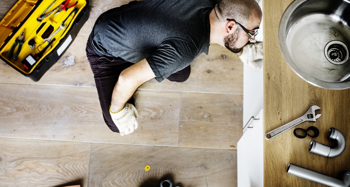 5 Telltale Signs You Need Professional Drain Cleaning 1 – signs you need professional drain cleaning Man fixing kitchen sink