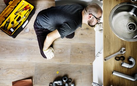 5 Telltale Signs You Need Professional Drain Cleaning 7 – Linear Drain Man fixing kitchen sink