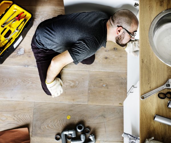 Man fixing kitchen sink